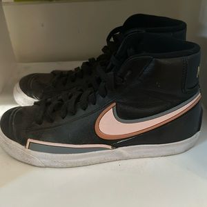 Black blazers with pink Nike symbol